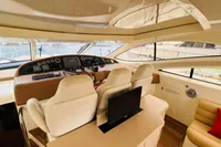 2008 Astondoa Open 53 yacht interior with helm, beige seating, and panoramic windows.