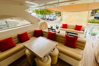 Luxurious 2008 Astondoa Open 53 yacht interior with beige seating and red cushions.