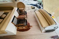 Luxurious seating area on 2008 Astondoa Open 53 yacht with wooden deck and cushioned benches.