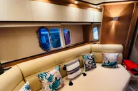 Luxurious interior of 2008 Astondoa Open 53 yacht with elegant seating and decorative pillows.