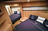 Luxurious cabin interior of 2008 Astondoa Open 53 yacht with nautical-themed bedding.