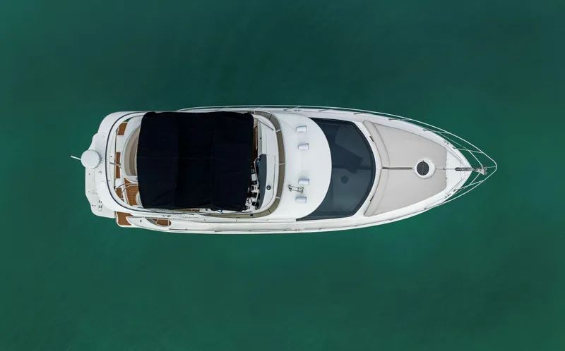 Crescendo Yacht Photos Pics Aerial view of a 2012 Meridian Sedan Bridge yacht on calm water.