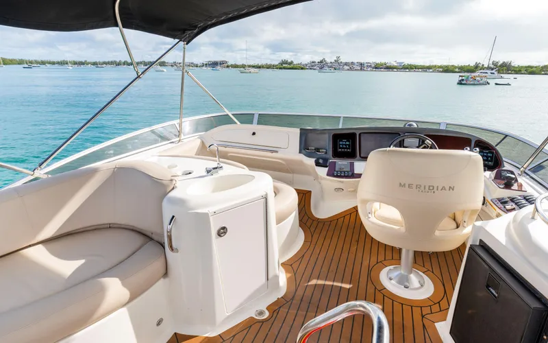 Crescendo Yacht Photos Pics 2012 Meridian Sedan Bridge yacht interior with helm, seating, and ocean view.