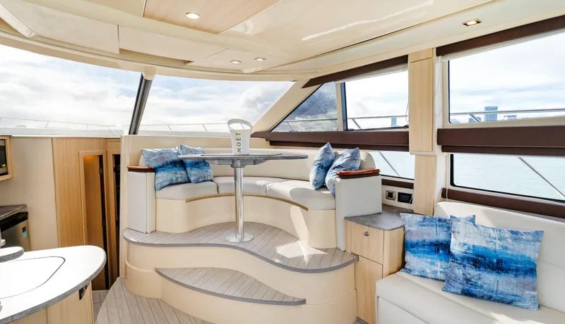 Crescendo Yacht Photos Pics Luxurious interior of 2012 Meridian Sedan Bridge yacht with panoramic windows and plush seating.