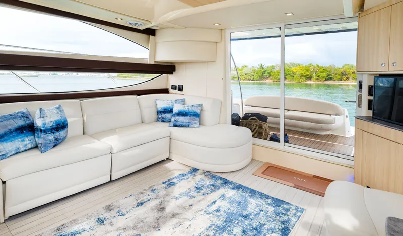 Crescendo Yacht Photos Pics Luxurious interior of 2012 Meridian Sedan Bridge yacht with white leather seating and scenic water view.