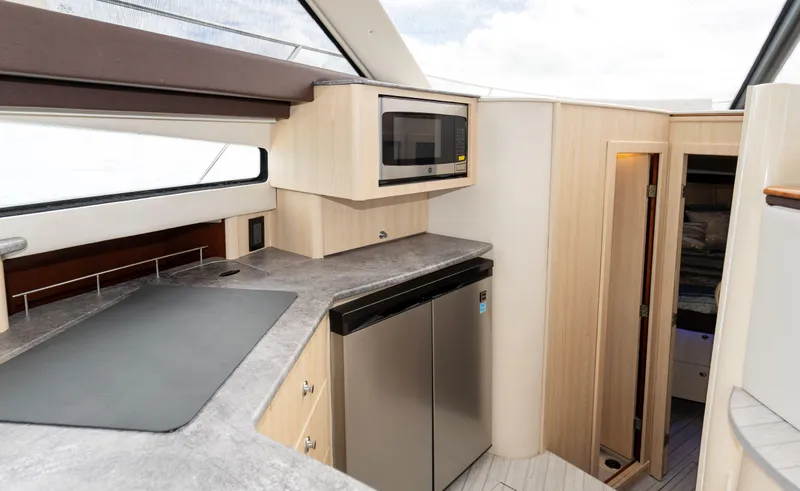 Crescendo Yacht Photos Pics Modern kitchen area in 2012 Meridian Sedan Bridge yacht with stainless steel appliances.