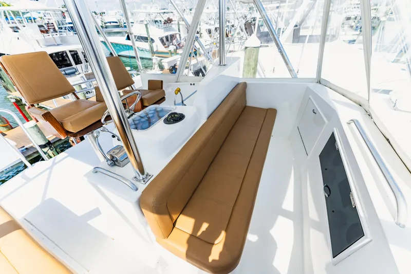  Yacht Photos Pics 1984 Ocean Yachts 46 interior with tan seating and helm, docked at marina.
