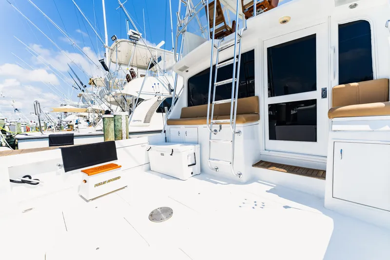  Yacht Photos Pics 1984 Ocean Yachts 46 boat deck with seating, ladder, and fishing equipment under clear blue sky.