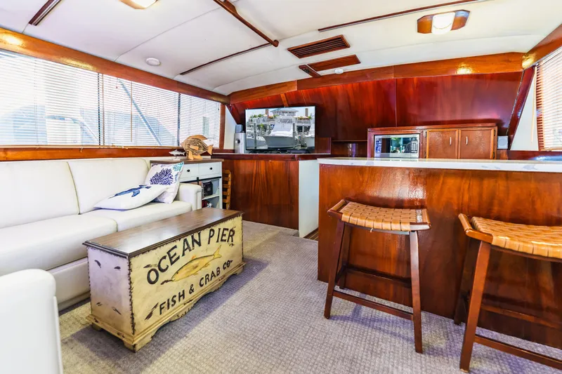  Yacht Photos Pics Interior of 1984 Ocean Yachts 46, featuring wood paneling, white sofa, and nautical decor.