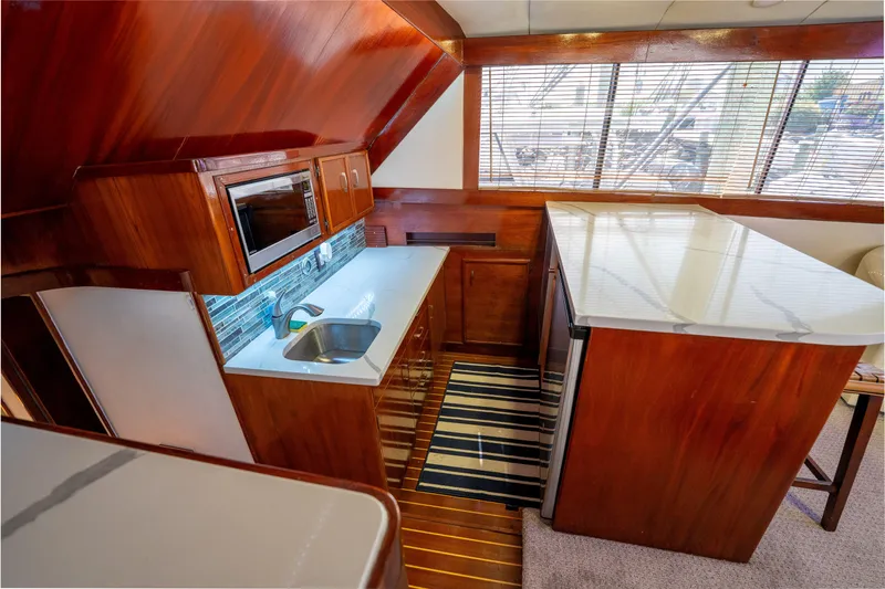  Yacht Photos Pics Luxurious 1984 Ocean Yachts 46 interior kitchen with wood finish and modern appliances.