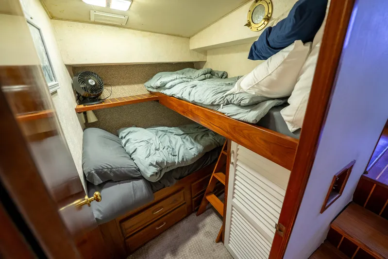  Yacht Photos Pics Cozy bunk beds in 1984 Ocean Yachts 46 cabin with wooden accents and porthole.