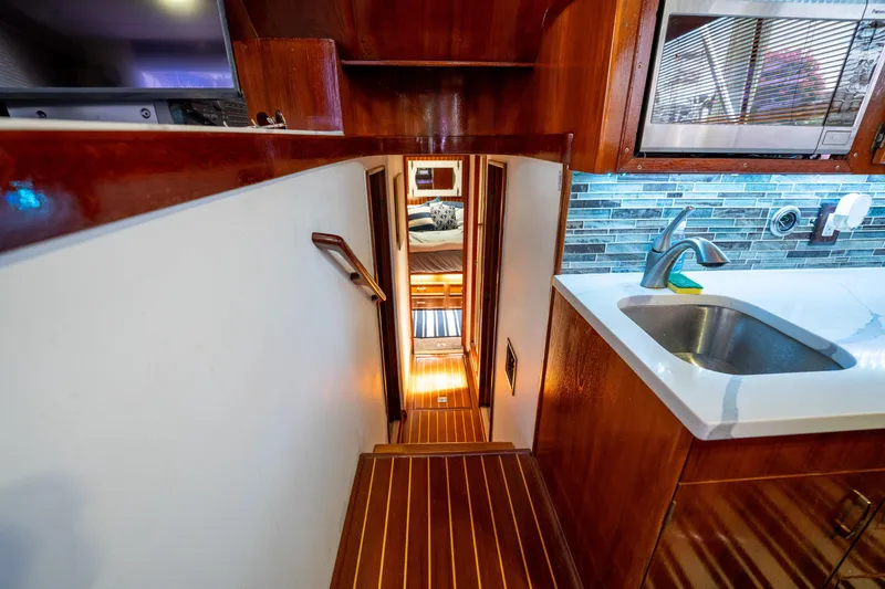  Yacht Photos Pics Interior of 1984 Ocean Yachts 46, featuring wooden stairs and modern kitchen area.