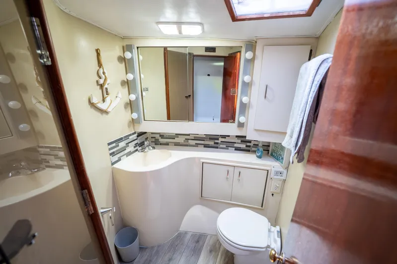  Yacht Photos Pics Bathroom interior of 1984 Ocean Yachts 46, featuring modern fixtures and nautical decor.
