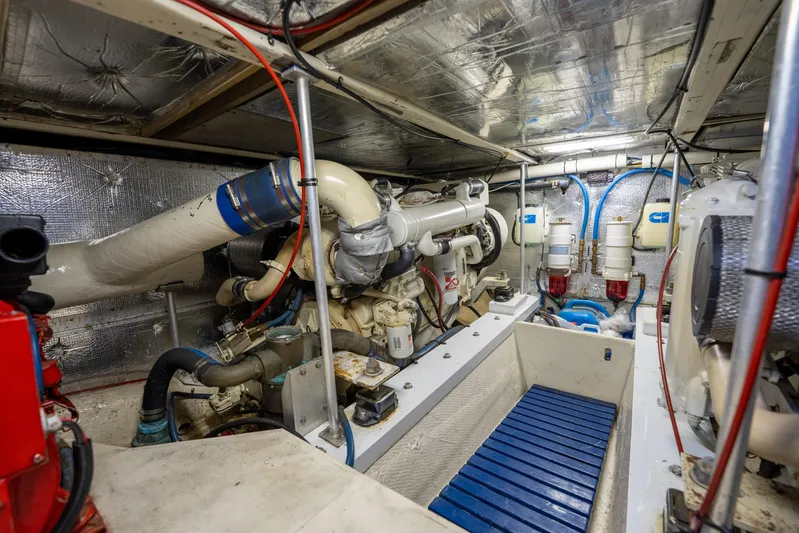  Yacht Photos Pics Engine room of a 1984 Ocean Yachts 46, showcasing mechanical components and piping.