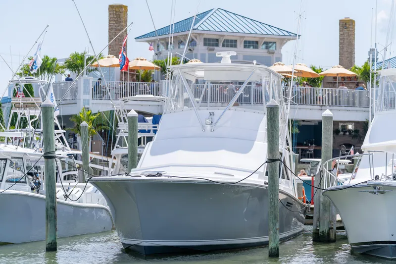  Yacht Photos Pics 1984 Ocean Yachts 46 docked at marina with waterfront restaurant in background.