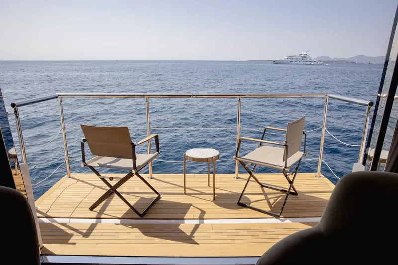 Haiami Yacht Photos Pics Deck view from 2022 Custom Line Navetta 33 yacht, featuring chairs and ocean scenery.