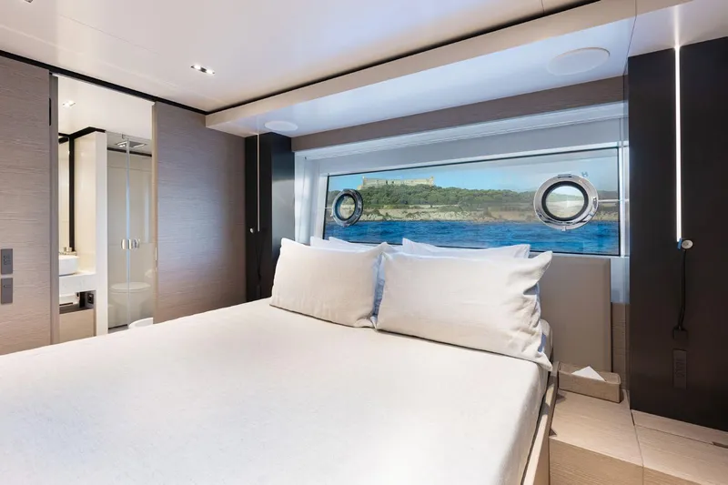 Haiami Yacht Photos Pics Luxurious bedroom interior of 2022 Custom Line Navetta 33 yacht with scenic ocean view.