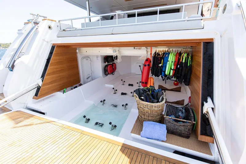 Haiami Yacht Photos Pics Luxurious 2022 Custom Line Navetta 33 yacht with open storage area and water sports equipment.