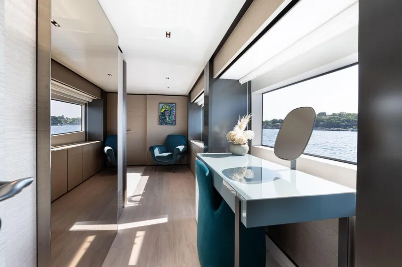 Haiami Yacht Photos Pics Luxurious interior of 2022 Custom Line Navetta 33 yacht with elegant furnishings and large windows.