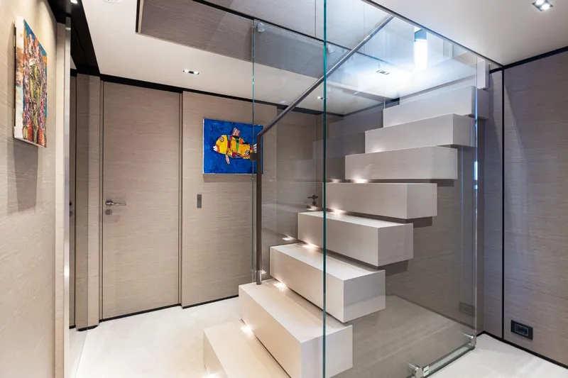 Haiami Yacht Photos Pics Modern interior of 2022 Custom Line Navetta 33 yacht with sleek glass staircase.
