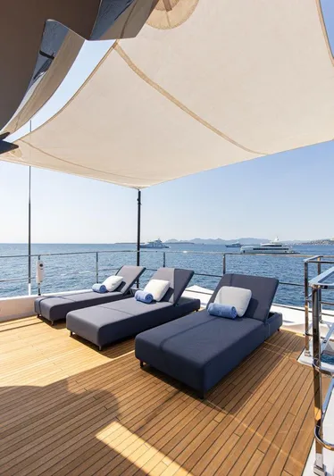 Haiami Yacht Photos Pics Luxury sun deck on 2022 Custom Line Navetta 33 yacht with loungers and ocean view.