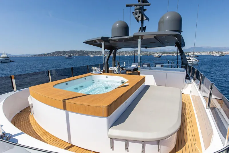 Haiami Yacht Photos Pics Luxurious 2022 Custom Line Navetta 33 yacht with jacuzzi on deck, cruising in scenic waters.