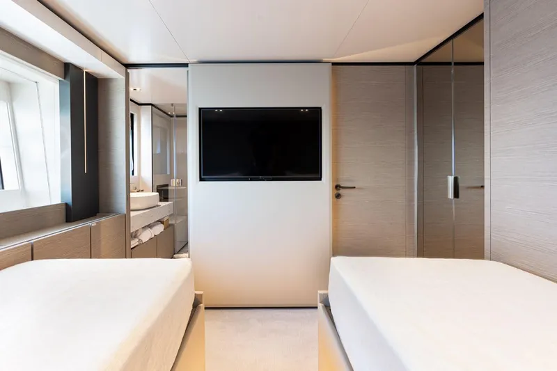 Haiami Yacht Photos Pics Luxurious twin bedroom on 2022 Custom Line Navetta 33 yacht with modern decor and TV.