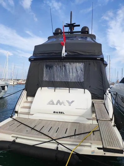  Yacht Photos Pics 2023 Cranchi Sessantasette 67 yacht docked at marina, rear view with canopy.