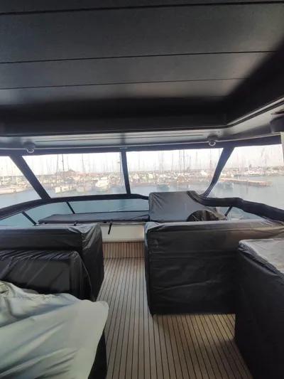  Yacht Photos Pics Interior view of 2023 Cranchi Sessantasette 67 yacht with marina backdrop.