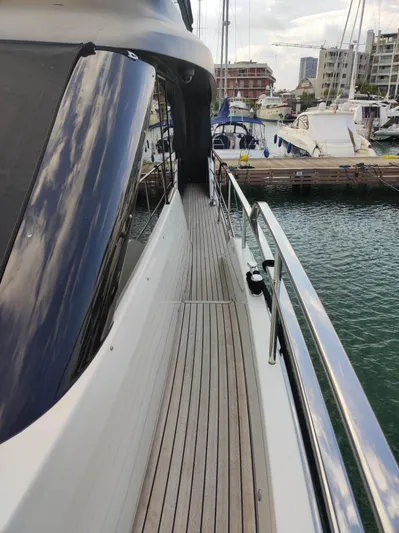  Yacht Photos Pics 2023 Cranchi Sessantasette 67 yacht docked, showcasing sleek deck and modern design.