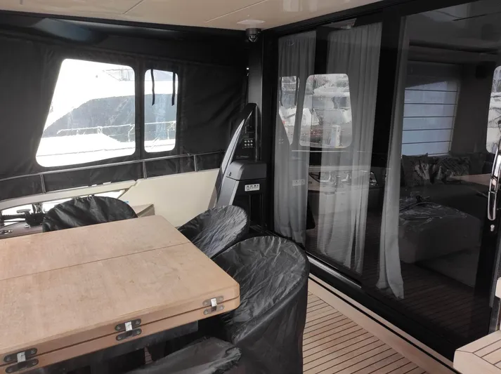  Yacht Photos Pics 2023 Cranchi Sessantasette 67 yacht interior with dining area and sliding glass doors.