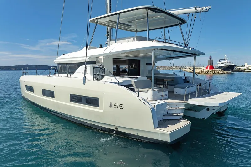 Saliska Yacht Photos Pics 2023 Lagoon 55 catamaran on calm blue water, showcasing modern design and spacious deck.