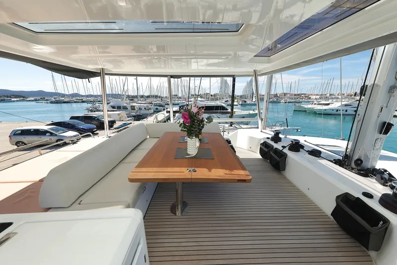 Saliska Yacht Photos Pics Luxurious 2023 Lagoon 55 yacht interior with elegant seating and ocean view.