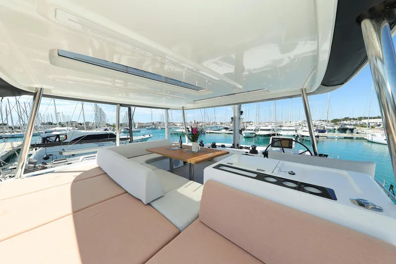 Saliska Yacht Photos Pics Luxurious 2023 Lagoon 55 yacht interior with spacious seating and marina view.