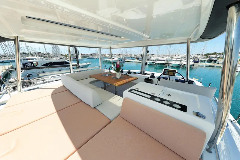 Saliska Yacht Photos Pics Luxurious 2023 Lagoon 55 yacht interior with spacious seating and marina view.