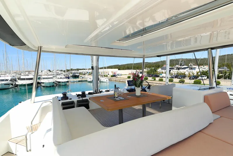 Saliska Yacht Photos Pics Luxurious Lagoon 55 yacht interior, 2023 model, featuring elegant seating and scenic marina views.