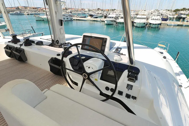 Saliska Yacht Photos Pics Helm of 2023 Lagoon 55 yacht in marina, featuring modern navigation equipment.