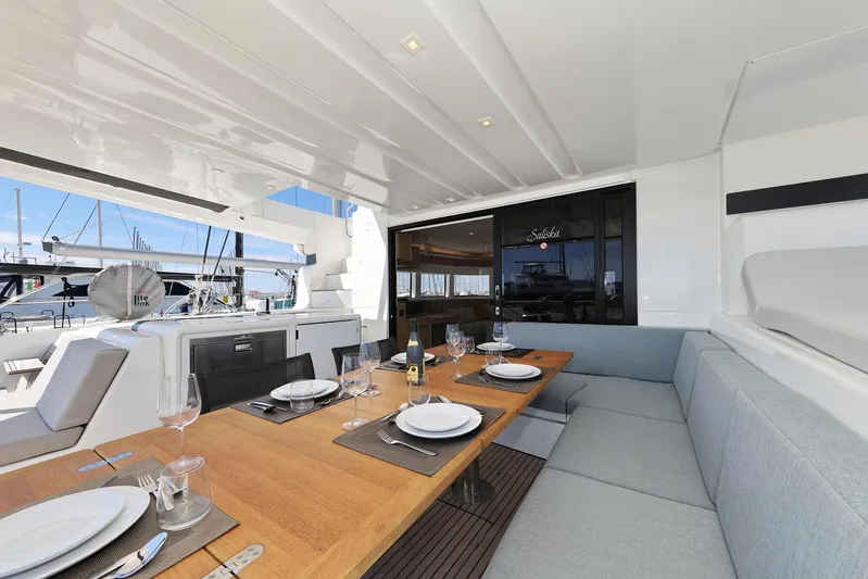 Saliska Yacht Photos Pics Luxurious 2023 Lagoon 55 yacht interior with elegant dining setup and modern seating.