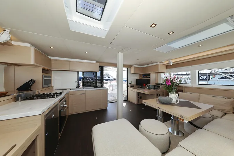 Saliska Yacht Photos Pics Luxurious interior of 2023 Lagoon 55 yacht with modern kitchen and seating area.