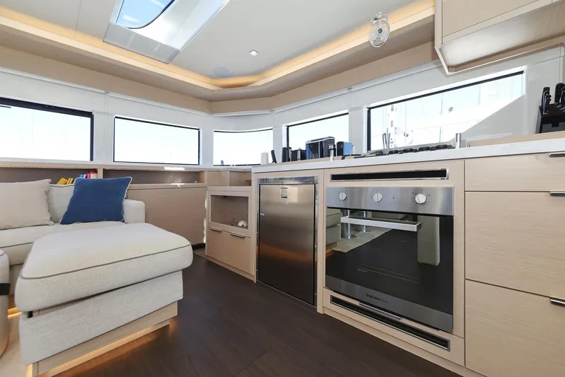 Saliska Yacht Photos Pics Modern kitchen interior of 2023 Lagoon 55 yacht with sleek appliances and cozy seating.