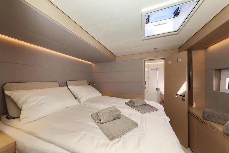 Saliska Yacht Photos Pics Luxurious cabin interior of 2023 Lagoon 55 yacht with double bed and skylight.