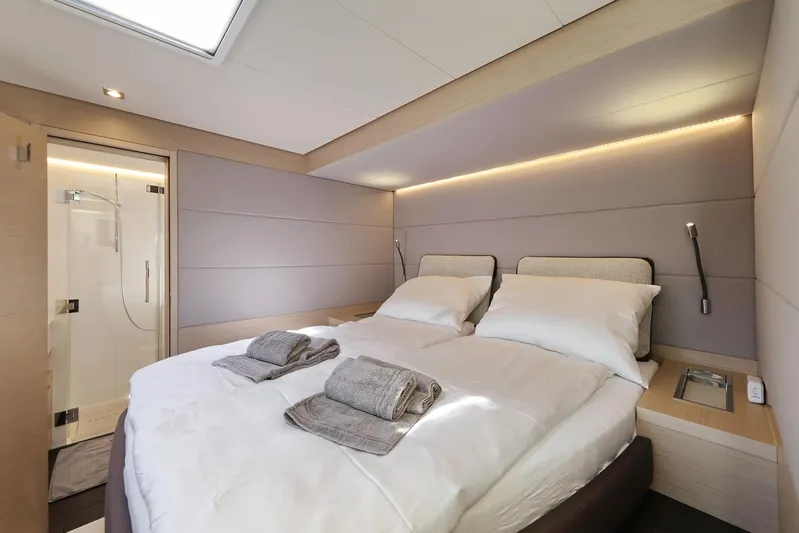 Saliska Yacht Photos Pics Luxurious bedroom interior of 2023 Lagoon 55 yacht with modern design and ensuite bathroom.