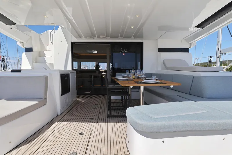 Saliska Yacht Photos Pics Luxurious Lagoon 55 yacht deck, 2023 model, featuring elegant seating and dining area.
