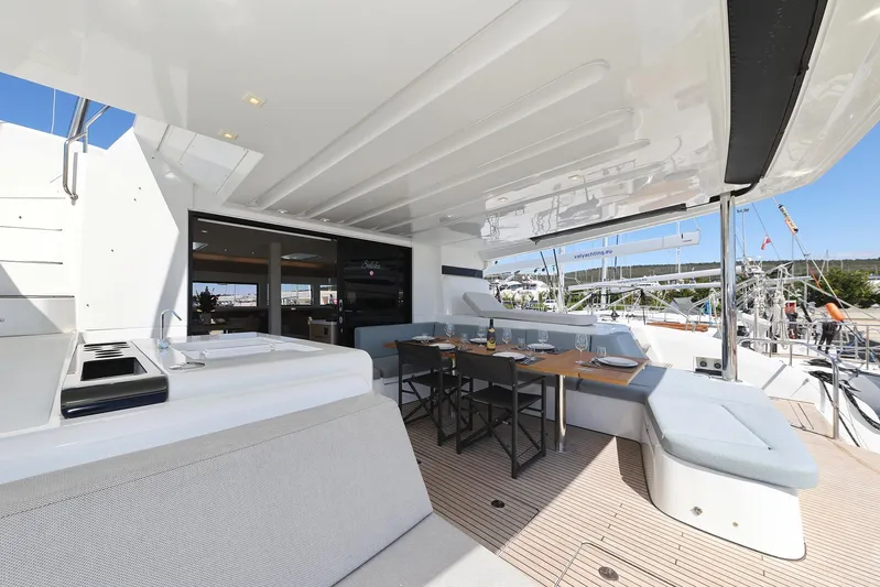 Saliska Yacht Photos Pics Luxurious 2023 Lagoon 55 yacht deck with seating and dining area.