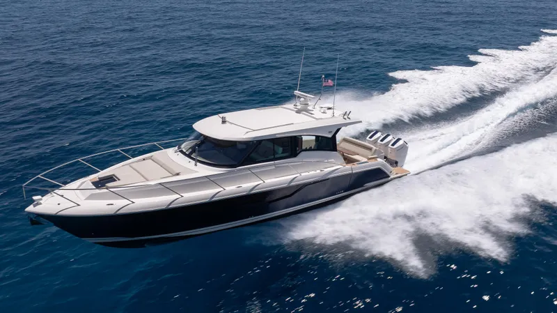  Yacht Photos Pics 2024 Tiara Yachts 48 LE cruising on open water, showcasing sleek design and powerful performance.