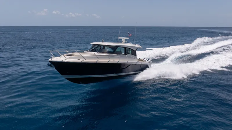  Yacht Photos Pics 2024 Tiara Yachts 48 LE cruising swiftly on open ocean waters.