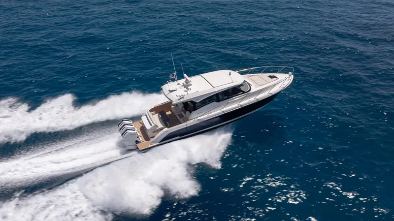  Yacht Photos Pics 2024 Tiara Yachts 48 LE cruising on open ocean, showcasing sleek design and powerful performance.