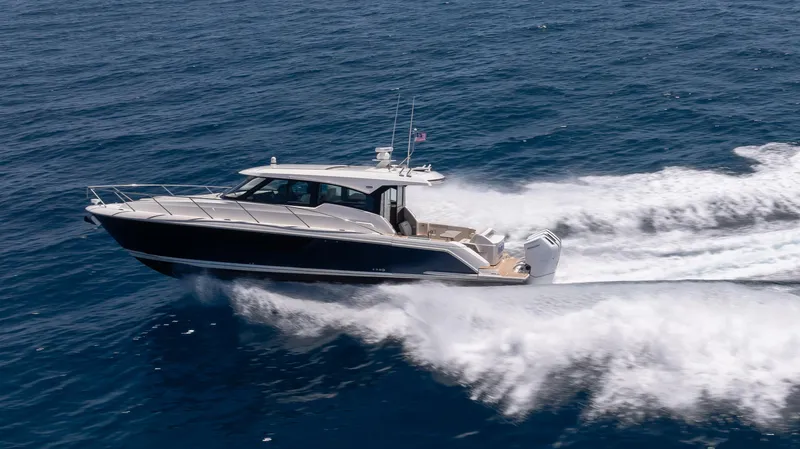  Yacht Photos Pics 2024 Tiara Yachts 48 LE cruising swiftly on open ocean waters.