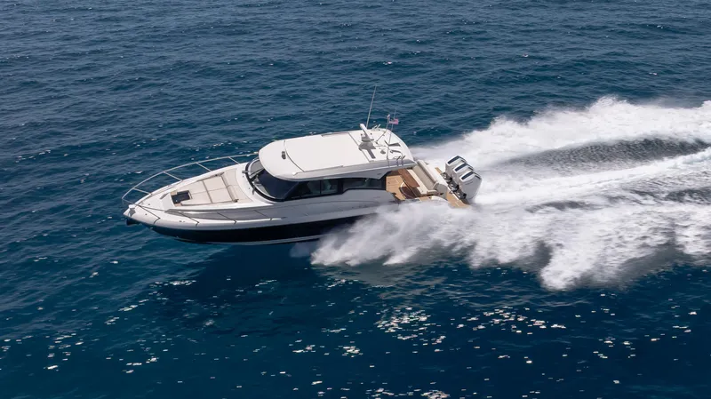  Yacht Photos Pics 2024 Tiara Yachts 48 LE cruising swiftly on open blue waters.