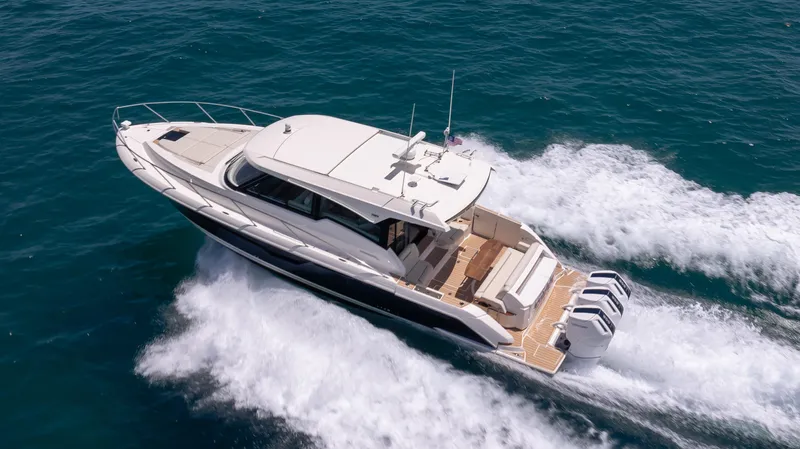  Yacht Photos Pics 2024 Tiara Yachts 48 LE cruising on open water, showcasing sleek design and powerful engines.